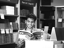 Student reading book in a library