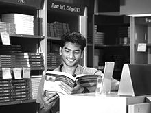 Student reading book in a library