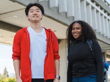 Two students smiling and looking at the camera.