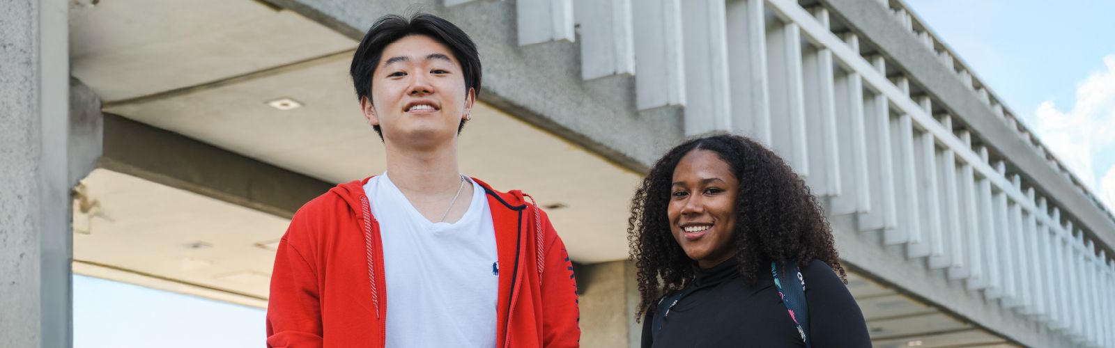 Two students smiling and looking at the camera.